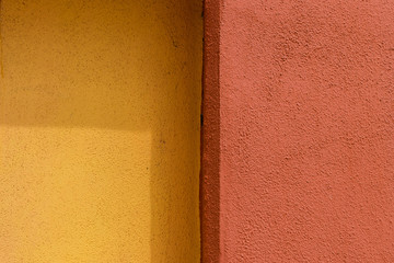 Fototapeta premium Plaster texture of yellow and red color - Vertical stripes of different colors