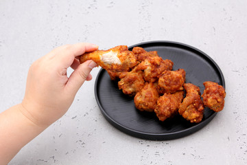 Korean fried chicken wings isolated on a gray background in studio.