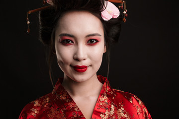 Image of happy geisha woman in traditional japanese kimono smiling