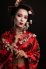 Image of brunette geisha woman in japanese kimono with sakura tree