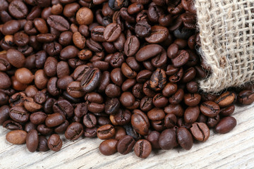 coffee beans with burlap sack on wooden background