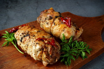 Chicken roll on a cutting Board, on a dark background. Healthy diet