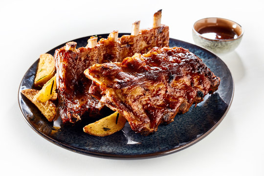Two racks of marinated spicy barbecued ribs