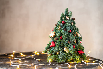 Christmas tree on a brown, wooden background.