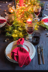 Christmas festive table setting with fir-tree branch and glasses