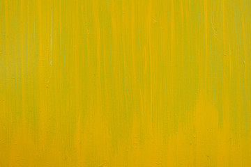 Yellow paint strokes on a metal sheet. Copy space