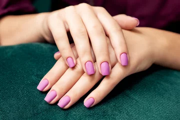 Fototapeten Perfect purple matte manicure on the woman's nails, close up. © okskukuruza