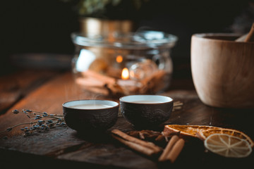 Chinese tea ceremony with ceramic cups with milk Oolong tea on wooden background. Traditional Asian drink, beautiful serving