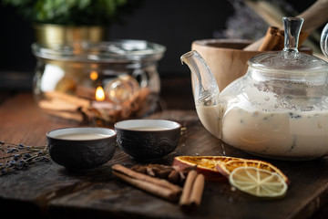 Chinese tea ceremony with ceramic cups with milk Oolong tea on wooden background. Traditional Asian drink, beautiful serving