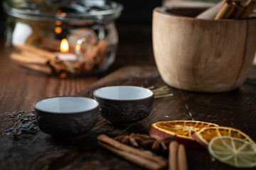 Obraz na płótnie Canvas Ceramic cups with herbs for Chinese tea ceremony on dark background.