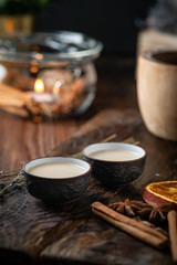 Chinese tea ceremony with ceramic cups with milk Oolong tea on wooden background. Traditional Asian drink, beautiful serving