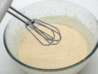 Broken eggs in a deep transparent plate. Dough for pancakes. Cooking food