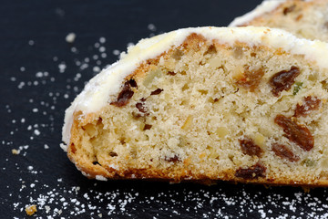 christmas stollen lying on black shale at christmas time