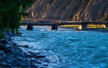 Wooden bridge over the Chuya river in the Altai Republic