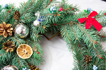 a Christmas pine wreath with natural ornaments isolated on white