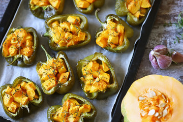 Paprika peppers stuffed with pumpkin. Baked paprika with pumpkin. Vegan lunch. Autumn food. Selective focus. Macro.