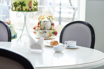 Fruit tea and delicious fresh croissant on the table in a cozy coffee shop