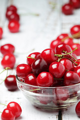 A small glass bowl with ripe fresh cherry