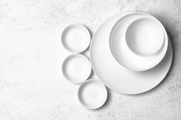 White plates isolated on a light background. Table setting. Top view copy space.