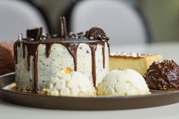 Delicious chocolate cake, cake and chocolate roll on a table in a cozy coffee shop
