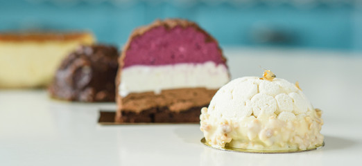 Different delicious and beautiful cakes on the table in a cozy coffee shop