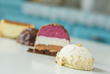 Different delicious and beautiful cakes on the table in a cozy coffee shop