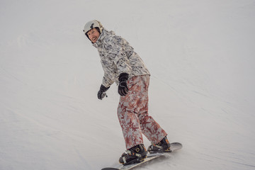 Male snowboarder at a ski resort in winter