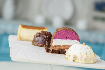 Different delicious and beautiful cakes on the table in a cozy coffee shop