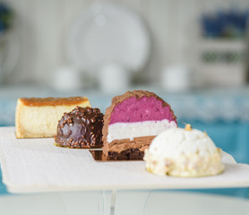 Different delicious and beautiful cakes on the table in a cozy coffee shop