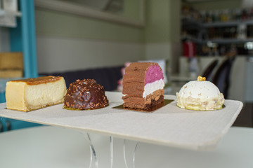 Different delicious and beautiful cakes on the table in a cozy coffee shop