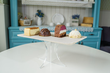 Different delicious and beautiful cakes on the table in a cozy coffee shop