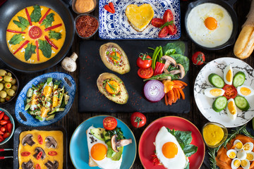 Fried eggs, boiled eggs and omelette on the rustic table