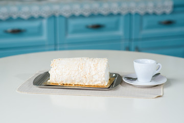 A delicious roll of bezrukov and a cup of coffee on a table in a cozy coffee shop