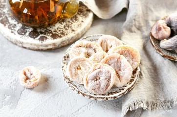Fototapeta premium Dried figs with tea in a glass teapot