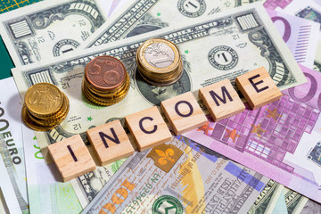 Fototapeta premium word text income on the money banknotes background