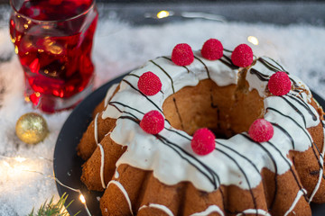 Beautiful festive cupcake decorated with whipped squirrels and raspberry jelly. Stands in artificial snow.