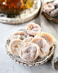 Dried figs with tea in a glass teapot