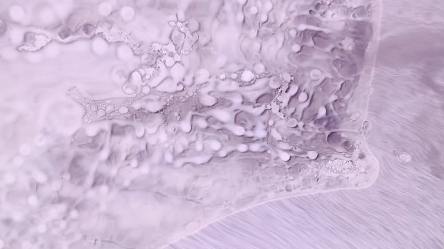 Pale pink lavender color paint flow abstract background footage. Contemporary fluid art animation. Acrylic and oil paints popping bubbles effect motion. Watercolor spreading close up