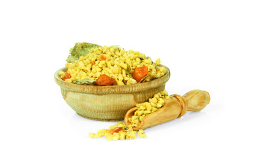 A mixture of dried vegetables in a wooden cup with a spoon for spices isolated on a white background. Collection of spices and herbs