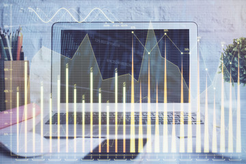 Stock market chart hologram drawn on personal computer background. Multi exposure. Concept of investment.