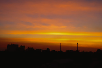 Silhouette of Beautiful sunset with television antenna or telecommunications towers have a lot of different antennas, Orange sky with sun and clouds. Nature background.