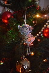 Toys on christmas tree with bright lights