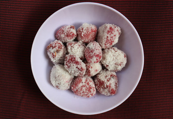 Imli laddu or Ram Laddu dusted with powdered sugar in a bowl