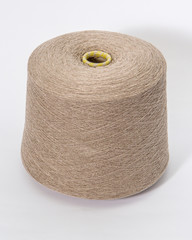 Green bobbin of yarn on a white background.Textile reel on isolated white background.