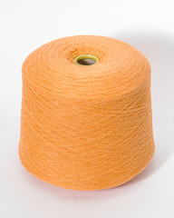 Green bobbin of yarn on a white background.Textile reel on isolated white background.