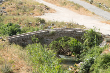 Fototapeta na wymiar The old bridge near the Mseilha Fort along the road that connects Byblos to Tripoli. Batroun, Lebanon - June, 2019