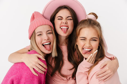 Image of pretty girls wearing pink clothes smiling and hugging together