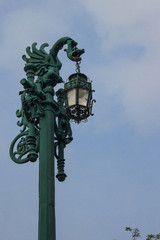Fototapeta na wymiar Elegant street lamp isolated on blue sky, with dragon sculpture