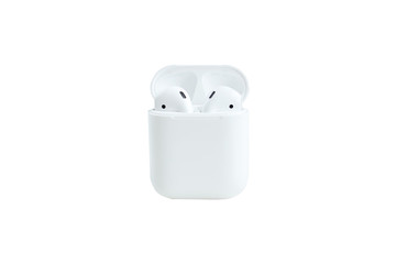 White wireless bluetooth headphones lie on a white background. The concept of modern technology,...