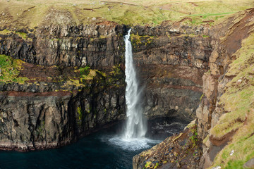 Fototapeta na wymiar Picturesque waterfall in the village Gasadalur in the Faroe Islands